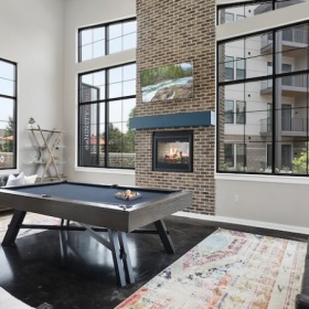 The NinetyNine Clubhouse Lounge Lounge with pool table, fireplace, tv, and seating